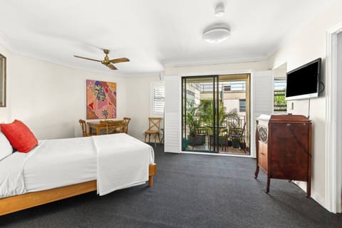 The open-plan studio layout brings together the dining and sleeping areas in one practical space, flowing out to a private balcony for easy inner-city stays.