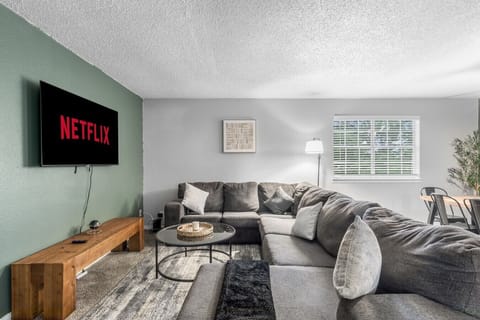 Spacious and inviting living area with comfortable seating and a smart TV, perfect for relaxing after exploring Arlington or attending events at AT&T Stadium.