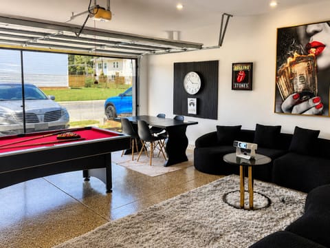 Spaces entertainment room with a pool table .A projector for movie night