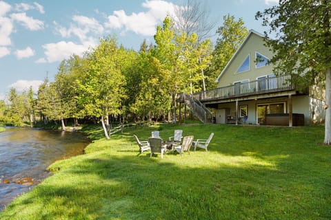 Relax by the fire pit on the lush lawn right next to the river.