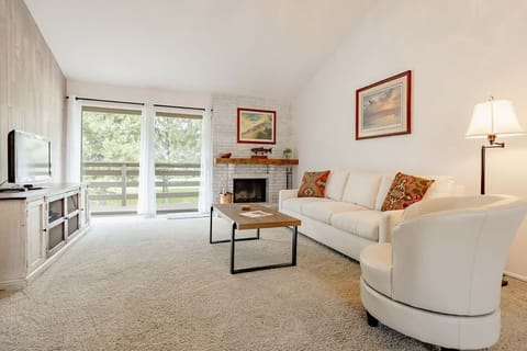 Bright living room with fireplace and patio doors