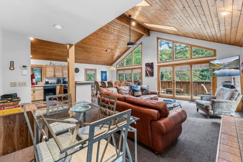 Open concept living space with soaring ceilings and huge windows