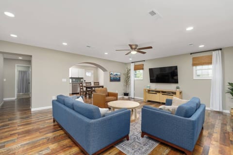 Living room features Article loveseat/sofa, Chita swivel chair, Pottery Barn media console, and a 65" Samsung TV.