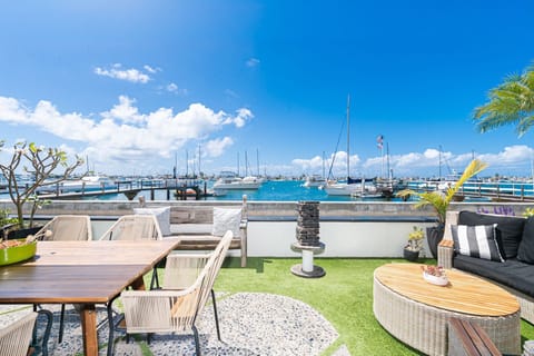 Bayfront patio with front-row views of Newport Harbor and Balboa Island boats
                