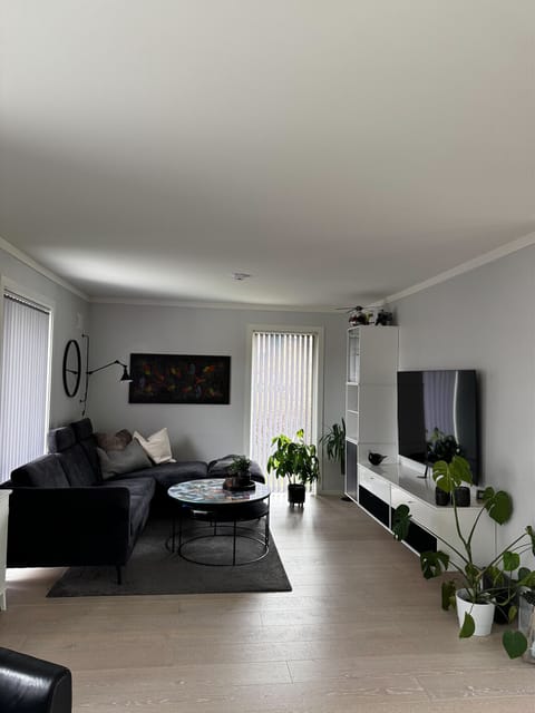 Cosy living room with a TV and access to the terrace outside