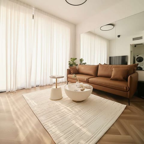 Cozy leather sofa beside tall curtains welcomes quiet downtime after exploring nearby cafés and markets.