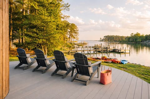 Sunset settles over the creek as Adirondack chairs, kayaks, and waterfront views invite you to slow down, relax, and get back to nature.