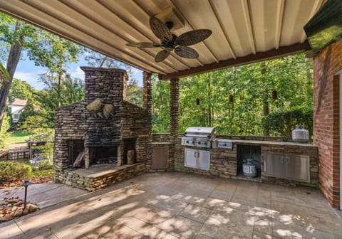 Outdoor kitchen with fire place- perfect location to make your meals and memories.