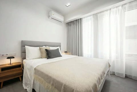 Plush bedding and blackout drapery encourage deep rest after full days exploring Athens.