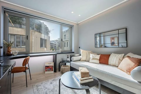 
Large windows flood the lounge with natural light, highlighting elegant furnishings and vibrant surroundings