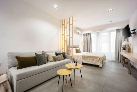 Sunlit lounge blends urban views with inviting textures, perfect for relaxed mornings or evening conversations.