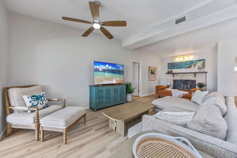 Relax in the spacious living room featuring a large sectional sofa and a cozy fireplace.
