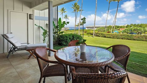 Step onto your private patio where a cozy seating area invites relaxation. Lounge on the sun chair or gather around the glass-top table while enjoying tropical breezes, manicured lawns, swaying palms, and serene ocean views.