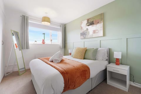 Well-appointed double bedroom featuring quality linens, warm bedside lighting, a mirror, and practical storage, ideal for relaxing short or extended stays.