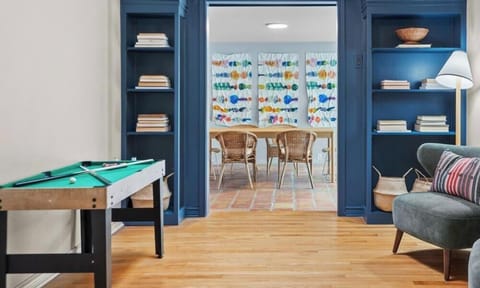 Challenge your crew to a round of pool or settle into an accent chair. Built-in shelves frame the game area.