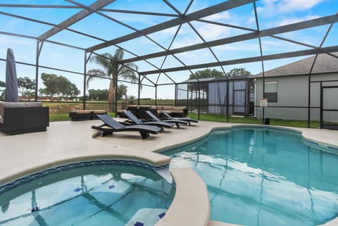 Relax by the screened pool and spa area with comfortable lounge seating.