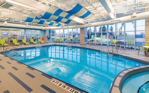 Indoor pool with colorful decor and comfortable lounge areas.