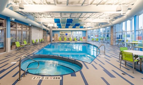 Bright indoor pool area with ample seating and natural light.