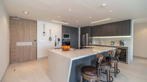 The kitchen is a chefs dream, stainless steel appliance, worth fridge, bar stools