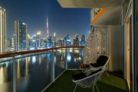 Private balcony with seating & swing, perfect for Burj views & relaxing moments.