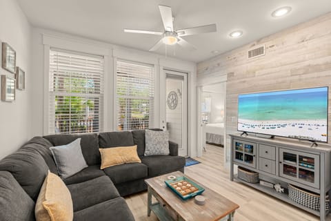 Settle into plush seating and enjoy your favorite shows on a large flat-screen TV, all while coastal breezes and natural light fill this bright, modern living space.