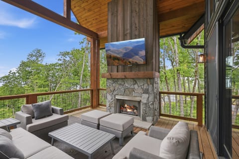 Relax on your covered mountain-view deck, complete with a cozy fireplace, comfortable lounge seating, and a TV — ideal for taking in the views in any weather.