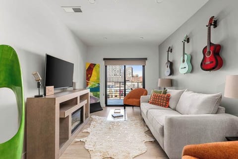 Stylish music-themed lounge featuring comfortable seating, modern decor, and bright natural light