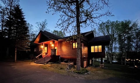 As the sun sets, the cabin glows with warmth, comfort, and quiet evenings.