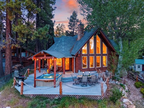 Twinkling lights, a private hot tub, and soaring windows make this mountain cabin the perfect place to unwind after a day of adventure.
