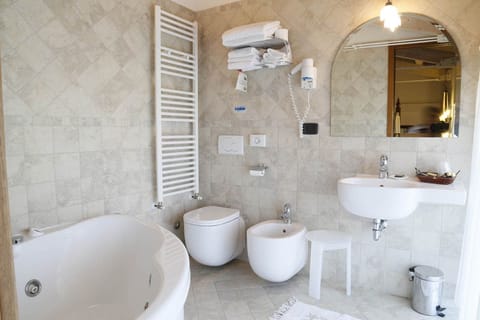 Deluxe Suite, Jetted Tub | Bathroom | Hair dryer, bidet, soap, shampoo