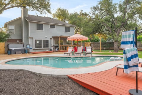 Your private backyard oasis awaits. Pool, hot tub, lounge deck, and mature shade trees — the ultimate Texas retreat. 