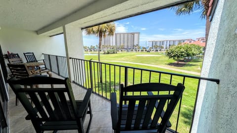 Large Covered balcony overlooks Hole #1 on Edgewater Par 3 Golf Course with Peek-A-Boo Gulf Views