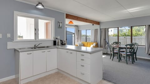 Living space combining kitchen, dining, and lounge.