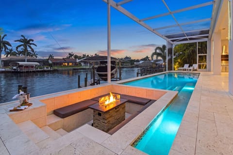 Canal Front 
Private Heated Pool & Jacuzzi
Designated Firepit 
Screened Lanai featuring outdoor kitchen 
Outdoor sofa, dining table & chairs