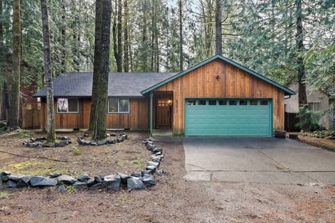 Exterior of the cabin tucked among the trees.