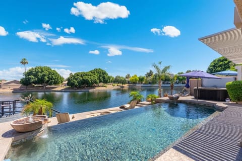 The pool's edge seems to dissolve right into the lake beyond — a seamless blend of water, sky, and desert landscape that's almost too beautiful to be real.