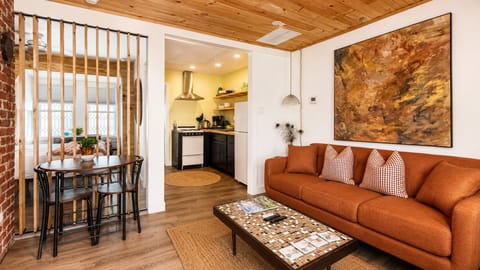 The wooden slat wall in the living room opens and closes for light and privacy