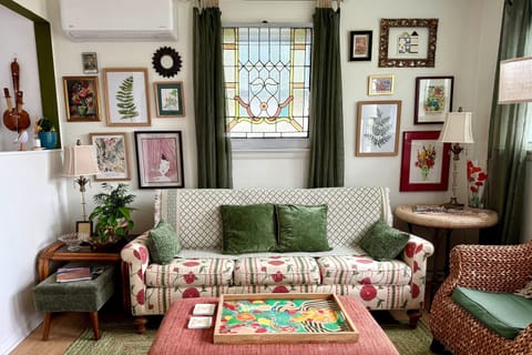 Bright and happy, that’s what we wanted, that anthropology style sofa, and the vintage stained glass set the tone for a cheerful space 