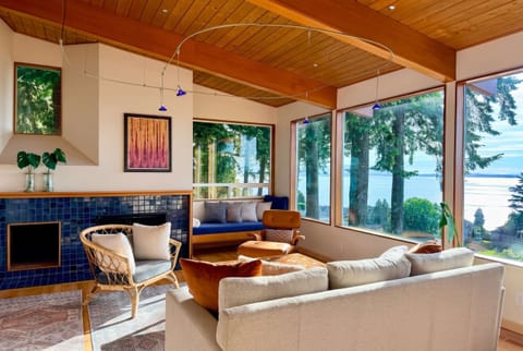 Welcome home. Surrounded by evergreens and overlooking Bellingham Bay, the living room captures the feeling of living in your own luxury treehouse.