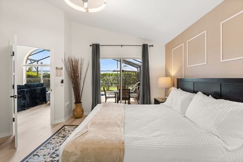 Retreat to the spacious primary king suite at Twice the Magic Retreat by Altespacio, featuring elegant furnishings, vaulted ceilings, and a peaceful atmosphere for restful nights.