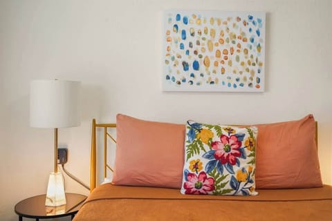 Elegant queen bedroom featuring a premium memory foam mattress, modern furnishings, soft linens, and a peaceful atmosphere perfect for relaxing after Disney adventures or tournament weekends in Kissimmee.