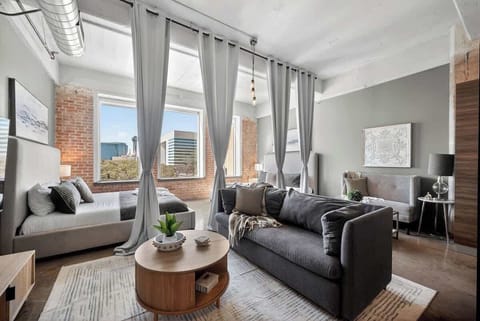 Room for everyone to relax together - oversized sectional, skyline backdrop, and space for 12 to gather in downtown Dallas.