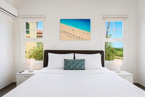 Spacious sunlit master bedroom with vaulted ceilings, open doors, and a bright, relaxing atmosphere.
