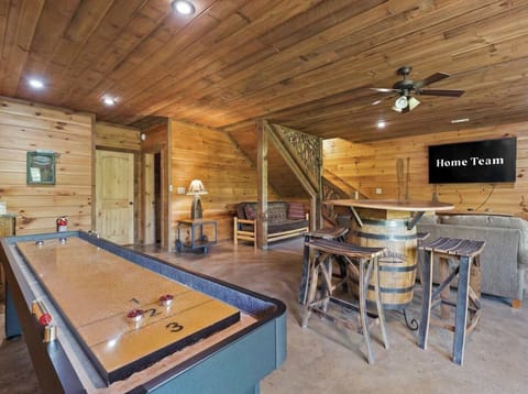  Let the good times roll! Challenge the crew to shuffleboard, pull up a stool at the barrel bar & catch the game on the flat screen — cabin nights don't get better than this. 