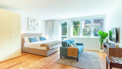 Bright and airy studio designed for slow mornings and relaxed city stays, with soft tones, natural wood floors, and garden-facing views. #PortoStay #StudioLiving #LovelyStay #ModernEscape