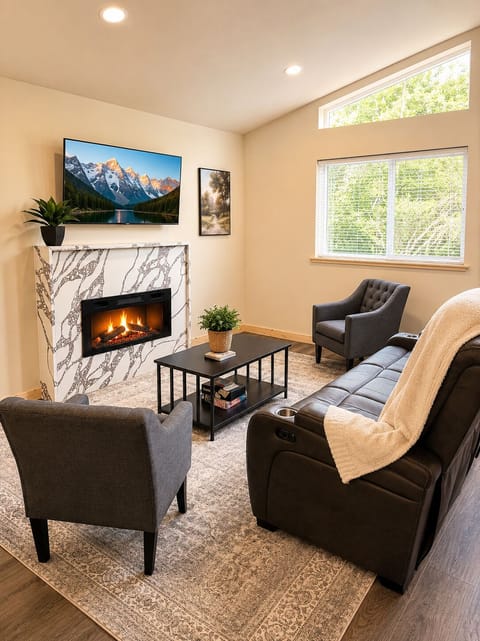 Fireplace, reclining sofa, and smart TV perfect for cozy nights. 