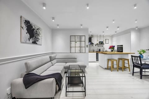 Modern Open-Plan Living Room with Designer Kitchen, Dining Area & Dedicated Workspace | Book Now with RENTUJEMY.COM