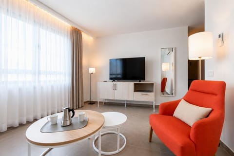 A modern open-plan living and dining area with elegant neutral decor.
