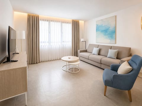 A modern open-plan living and dining area with elegant neutral decor.