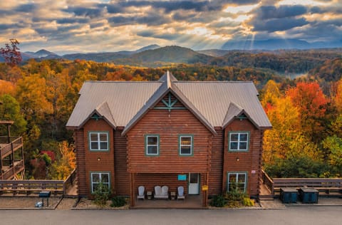 Luxury Smoky Mountain cabin exterior with expansive decks, private parking, and stunning fall mountain views in Sevierville TN near Gatlinburg and Pigeon Forge.